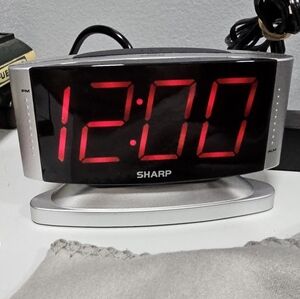 Sharp LED Digital Alarm Clock with a swivel base, model SPC033D. 